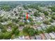 An aerial perspective of the home in a neighborhood with lush greenery, showcasing its lot and surrounding streets at 6204 Walsh Ln, Tampa, FL 33625