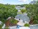 Rear aerial view of the home showing a patio, fenced yard and mature trees adding beauty and privacy at 6204 Walsh Ln, Tampa, FL 33625