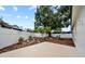 Private backyard featuring manicured landscaping, white fencing, and a serene outdoor space at 6204 Walsh Ln, Tampa, FL 33625