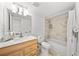 Bathroom with marble tiling, ample storage, and shower-tub combo at 6204 Walsh Ln, Tampa, FL 33625