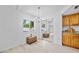 Bright dining room with modern light fixture, large window with natural light, and view of the yard at 6204 Walsh Ln, Tampa, FL 33625