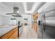 Well-lit kitchen features a cooktop island, stainless steel appliances, and eat in kitchen at 6204 Walsh Ln, Tampa, FL 33625