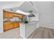 Open kitchen with stainless steel appliances, island with breakfast bar, and bright lighting at 6204 Walsh Ln, Tampa, FL 33625