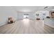 Open-concept living room featuring bright windows, hardwood floors, and modern finishes at 6204 Walsh Ln, Tampa, FL 33625