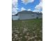 View of the back of the home and backyard area with a white vinyl fence at 7056 Landover Blvd, Spring Hill, FL 34608