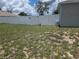 Spacious backyard enclosed with a white vinyl fence and gated access at 7056 Landover Blvd, Spring Hill, FL 34608