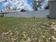 Spacious backyard enclosed with a white vinyl fence and gated access to the side at 7056 Landover Blvd, Spring Hill, FL 34608