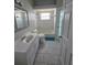 Bathroom featuring a sink, toilet, tub, and tile flooring at 7056 Landover Blvd, Spring Hill, FL 34608