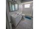 Bathroom with a sink, toilet, tub with shower, and tile flooring at 7056 Landover Blvd, Spring Hill, FL 34608