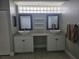 Bathroom featuring double sinks, vanity with cabinets, and large mirrors above the sinks at 7056 Landover Blvd, Spring Hill, FL 34608