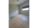 Cozy bedroom featuring wood flooring, natural light, and a ceiling fan at 7056 Landover Blvd, Spring Hill, FL 34608