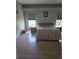 Bedroom with light wood flooring, picture window, and natural lighting at 7056 Landover Blvd, Spring Hill, FL 34608