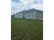 View of the side of the single Gathering home with access door and attached garage at 7056 Landover Blvd, Spring Hill, FL 34608