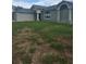 Charming single Gathering home with an attached two car garage, attractive architecture, and front yard at 7056 Landover Blvd, Spring Hill, FL 34608