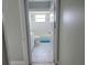 Hallway leading to bathroom with a bathtub and sink at 7056 Landover Blvd, Spring Hill, FL 34608
