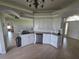 Kitchen with stainless dishwasher, granite countertop, white cabinets, and natural light at 7056 Landover Blvd, Spring Hill, FL 34608