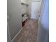 Laundry room featuring a utility sink, tile flooring, and white door at 7056 Landover Blvd, Spring Hill, FL 34608