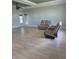 Bright living room with wood flooring and comfortable reclining furniture at 7056 Landover Blvd, Spring Hill, FL 34608