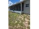 View of the back of the home featuring a screened in back porch at 7056 Landover Blvd, Spring Hill, FL 34608