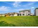 Large backyard with well-maintained lawn, backing onto neighboring homes at 7737 Rosewood Garden Loop, Tampa, FL 33637