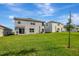 Expansive backyard with lush green grass and patio, perfect for outdoor entertaining at 7737 Rosewood Garden Loop, Tampa, FL 33637