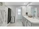 Clean bathroom featuring double sinks, a shower, and neutral color tones at 7737 Rosewood Garden Loop, Tampa, FL 33637