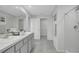 Bright bathroom featuring double vanity, tile flooring and a spacious walk-in closet at 7737 Rosewood Garden Loop, Tampa, FL 33637