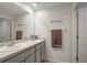 Modern bathroom with double sink vanity, large mirror, and towel rack at 7737 Rosewood Garden Loop, Tampa, FL 33637