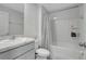 Clean bathroom with a shower-tub combo, toilet, and vanity with sink at 7737 Rosewood Garden Loop, Tampa, FL 33637