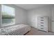 This bedroom is equipped with a twin bed, dresser and a window for natural light at 7737 Rosewood Garden Loop, Tampa, FL 33637