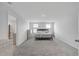 Spacious primary bedroom featuring carpet, a bed, and two windows at 7737 Rosewood Garden Loop, Tampa, FL 33637