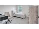 Cozy bedroom featuring a twin bed, study desk and plenty of natural light at 7737 Rosewood Garden Loop, Tampa, FL 33637