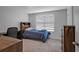 Bedroom with a large window, closet, desk, and dresser, offering lots of natural light at 7737 Rosewood Garden Loop, Tampa, FL 33637