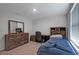 Bright bedroom with wooden furnishings including a desk, headboard, and dresser at 7737 Rosewood Garden Loop, Tampa, FL 33637