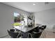 Dining area with a sliding glass door to the backyard and an modern dining table at 7737 Rosewood Garden Loop, Tampa, FL 33637