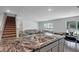 Open-concept kitchen with granite counters that looks to the stairs and living room at 7737 Rosewood Garden Loop, Tampa, FL 33637