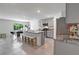 Bright kitchen with stainless appliances, stone countertops, ample seating, and a gray color scheme at 7737 Rosewood Garden Loop, Tampa, FL 33637