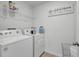 Well-equipped laundry room with a washing machine and dryer at 7737 Rosewood Garden Loop, Tampa, FL 33637