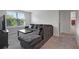 Comfortable living room featuring a large window, cozy couch and great natural light at 7737 Rosewood Garden Loop, Tampa, FL 33637