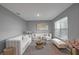 Bright living room with gray walls, modern white furniture, tasteful decor, and lots of sunlight at 7737 Rosewood Garden Loop, Tampa, FL 33637