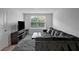 Comfortable living room with neutral carpet, lots of natural light and a large television at 7737 Rosewood Garden Loop, Tampa, FL 33637