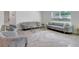 Bright living room featuring modern furniture, a stylish rug, and a window for natural light at 7737 Rosewood Garden Loop, Tampa, FL 33637
