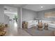 Living room view featuring tile floors, gray walls, modern furniture, and tasteful decor at 7737 Rosewood Garden Loop, Tampa, FL 33637