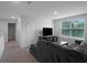 Upstairs living room offering a large window for natural light and a mounted television at 7737 Rosewood Garden Loop, Tampa, FL 33637