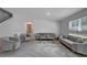Bright living room with modern gray furnishings, lots of space, and natural lighting at 7737 Rosewood Garden Loop, Tampa, FL 33637