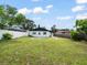 A spacious backyard featuring a white-fenced perimeter, green lawn, and a single-story house at 8233 44Th St N N St, Pinellas Park, FL 33781