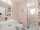 Bathroom with a blue shower curtain, vanity with a black faucet, and peach-colored walls at 8233 44Th St N N St, Pinellas Park, FL 33781