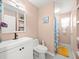 Bright bathroom featuring a shower, stylish vanity with storage, and peach-colored walls at 8233 44Th St N N St, Pinellas Park, FL 33781