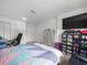Bright bedroom with a neutral-toned bed, a dresser and a large TV with a shoe display at 8233 44Th St N N St, Pinellas Park, FL 33781