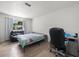 Bedroom featuring a comfortable bed, an office workspace, and nice window light at 8233 44Th St N N St, Pinellas Park, FL 33781
